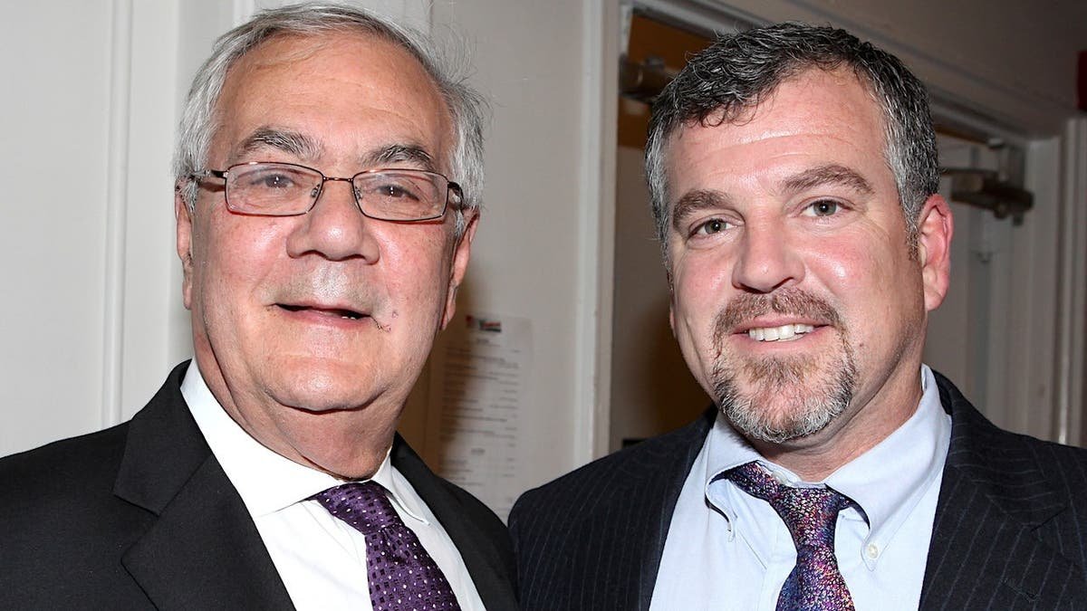Former Congressman Barney Frank and husband Jim Ready standing backstage