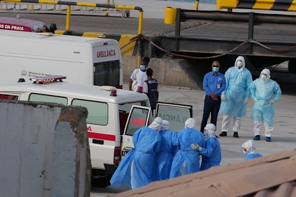 Health workers in protective gear evacuate patients from the MV Hondius cruise ship into an ambulance at a port in Praia, Cape Verde on Wednesday.