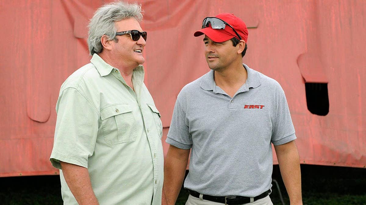 Brad Leland as Buddy Garrity and Kyle Chandler as Coach Eric Taylor standing together