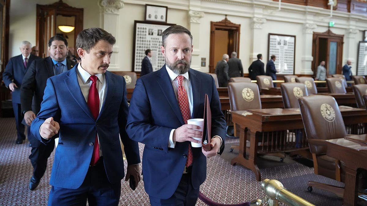 Rep. Briscoe Cain and Speaker Dustin Burrows walking outside the Texas Capitol