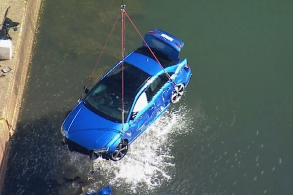 The Audi being craned out of the Hacking River after a fatal crash in the Royal National Park.