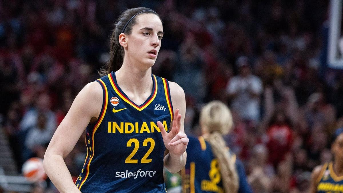 Indiana Fever guard Caitlin Clark celebrating a basket during a basketball game.