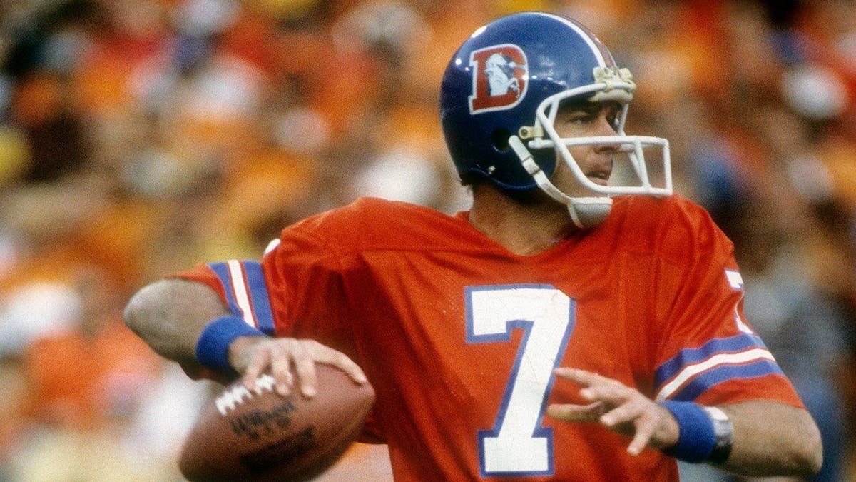 Quarterback Craig Morton dropping back to pass during an NFL game at Mile High Stadium