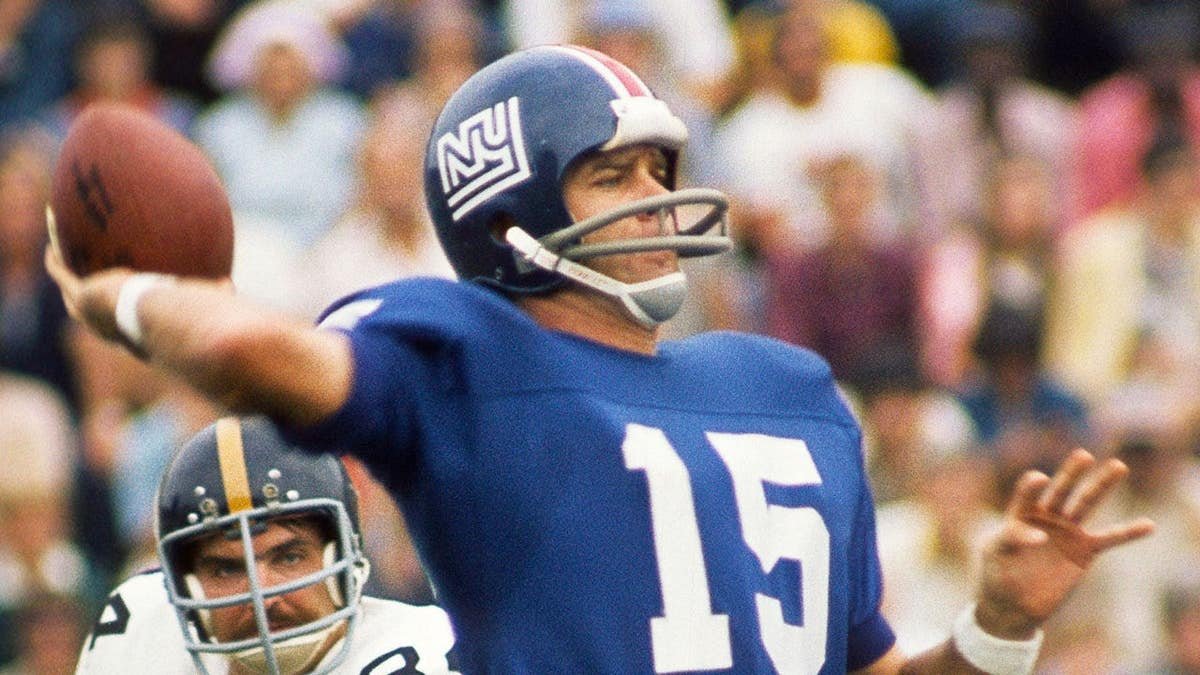 New York Giants quarterback Craig Morton throwing a football under pressure from Pittsburgh Steelers linebacker Andy Russell