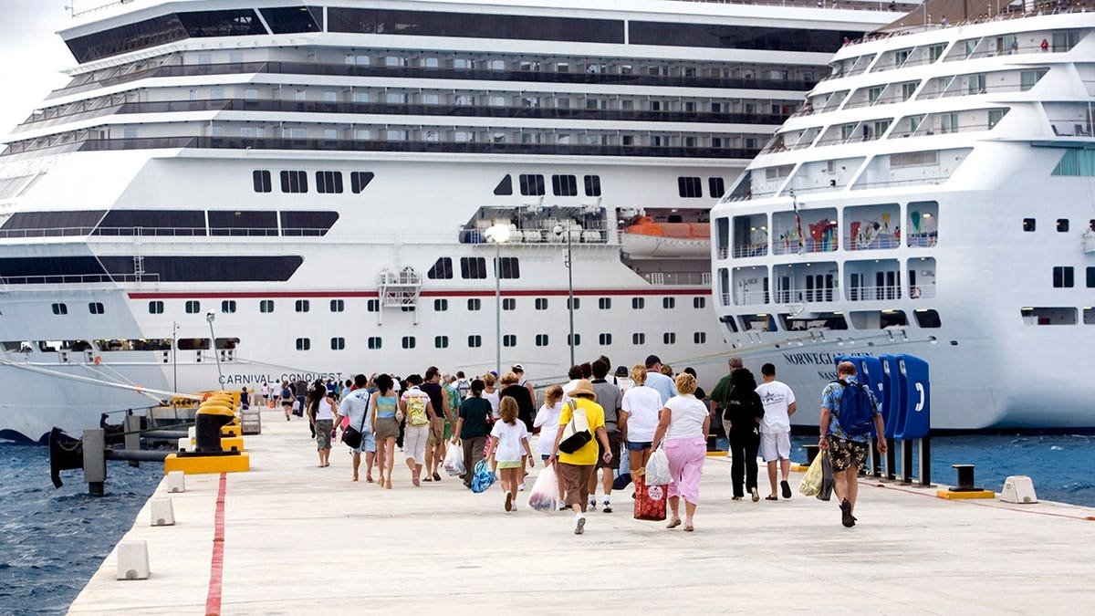 Passengers walking back to cruise boat at Cozumel port pier