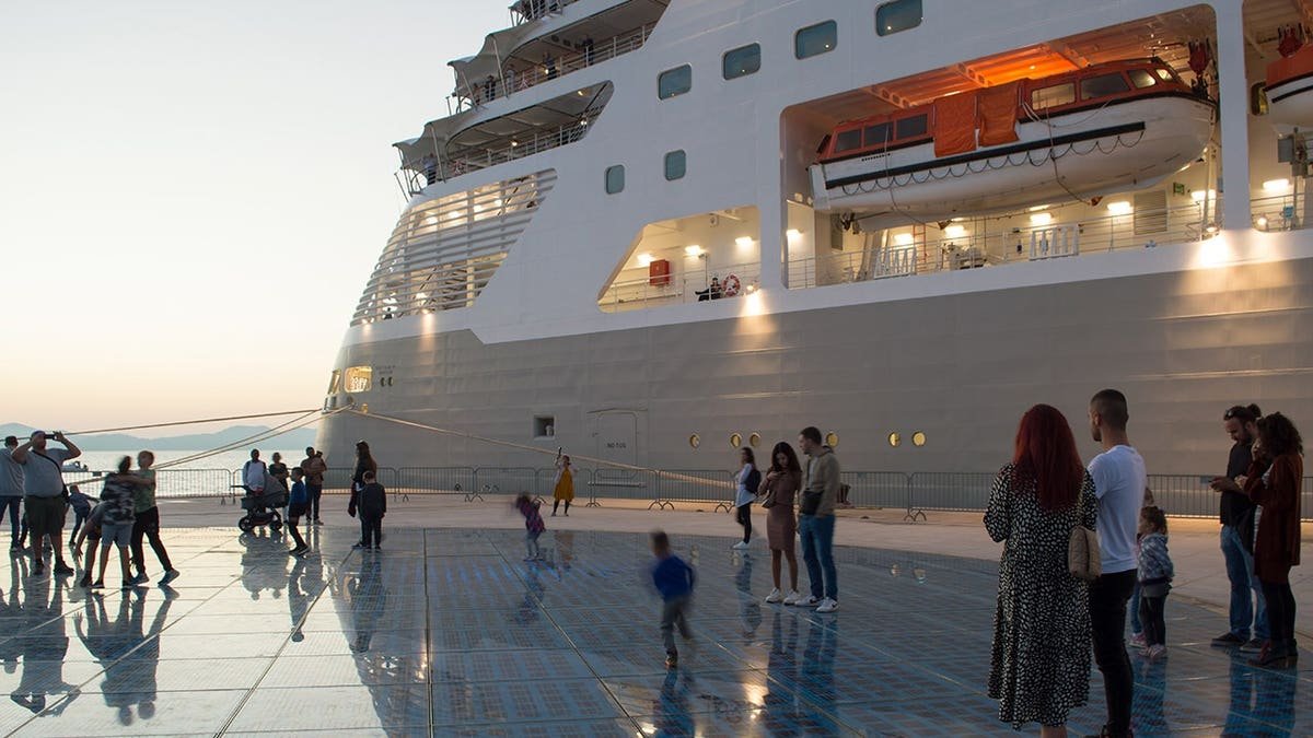 Families with children enjoying near cruise ship by Greetings to the Sun in Zadar Croatia