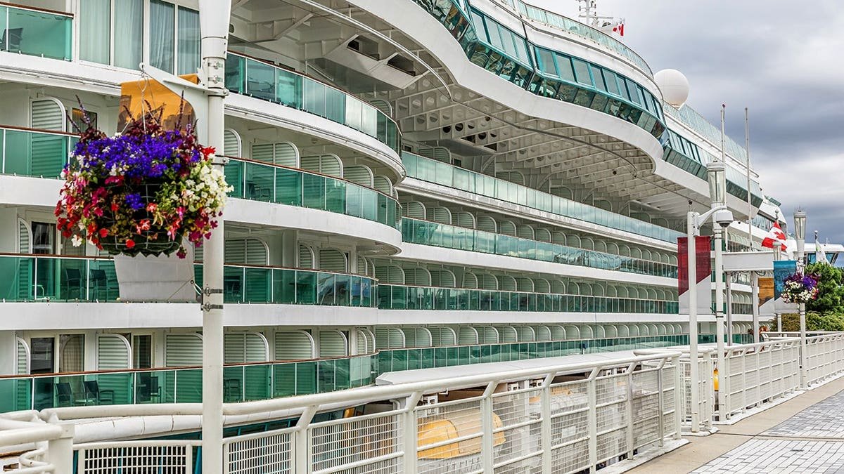 Side view of a cruise ship docked at the port of Vancouver with multiple balconies visible