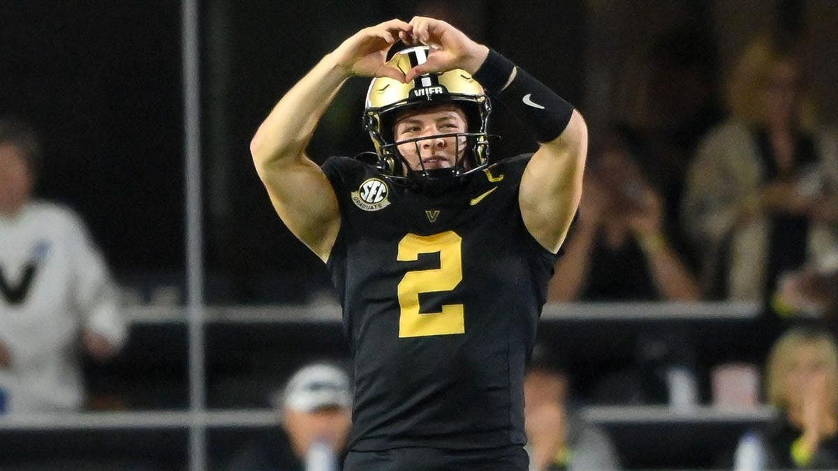 Vanderbilt Commodores quarterback Diego Pavia holding up a heart symbol at FirstBank Stadium