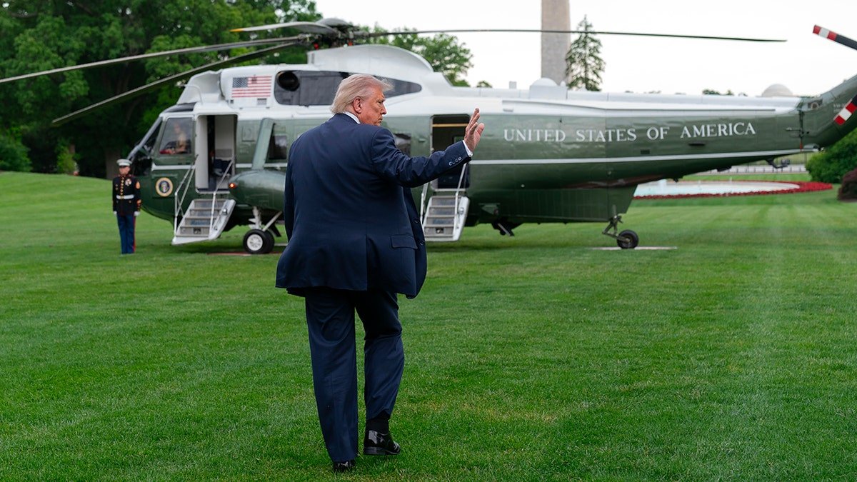 President Donald Trump waves while walking toward Marine One on the White House South Lawn