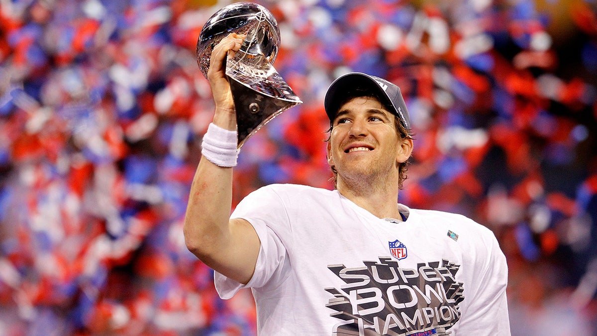 Quarterback Eli Manning holding the Vince Lombardi Trophy at Lucas Oil Stadium