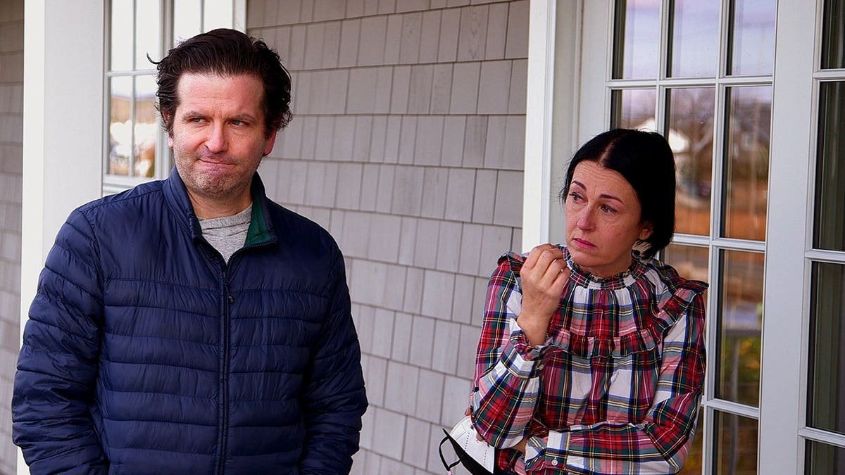 Eric and Shannon Evangelista listening emotionally outside a building