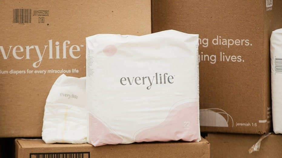 Boxes of EveryLife diapers stacked with packaged diapers in front