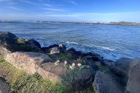 Tributes at the Ballina breakwall after yacht sailor Matthew Clayton and two volunteer rescuers, Bill Ewen and Frank Petsch, died.