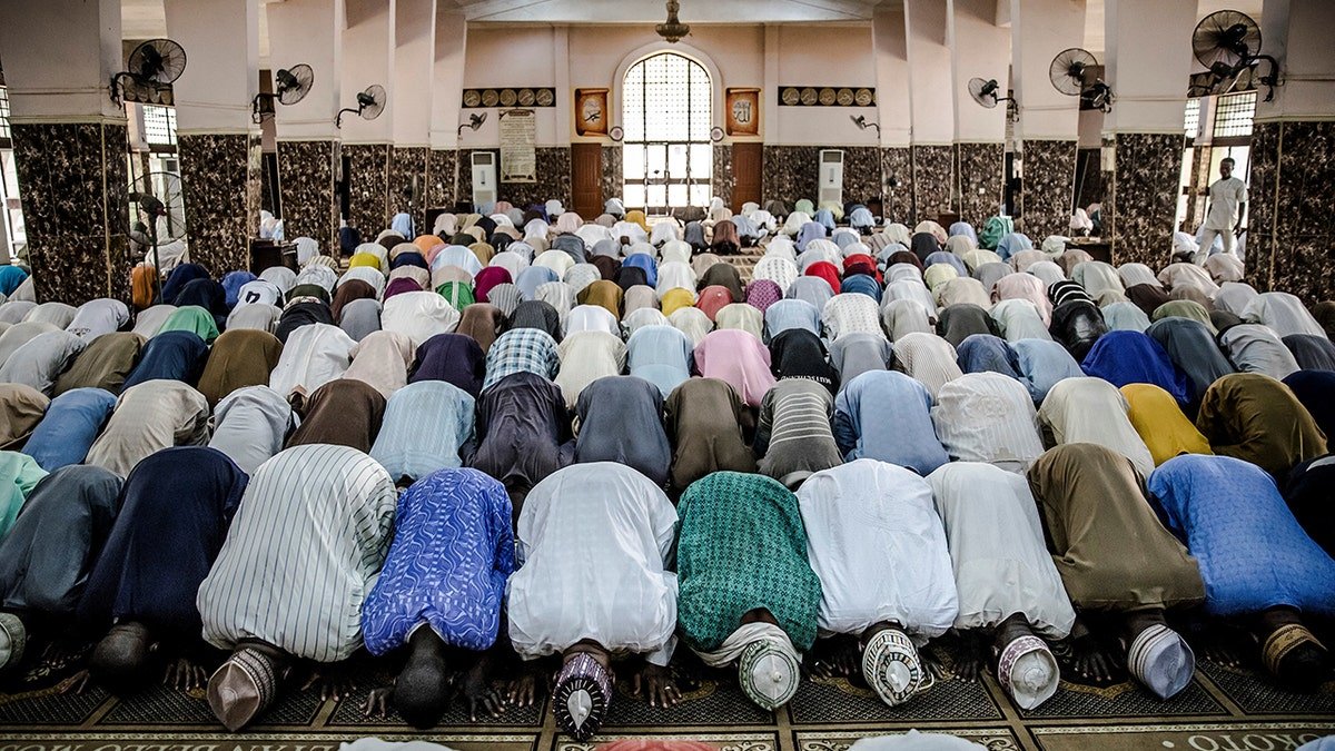 Fulani men praying