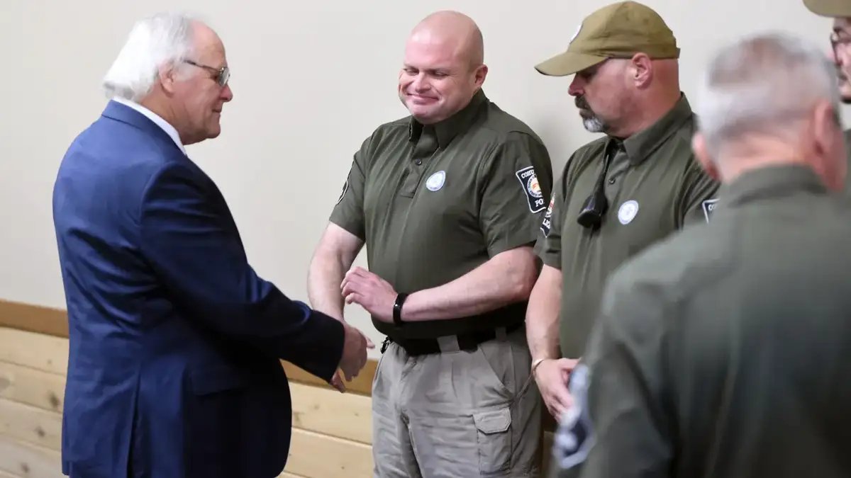 Mayor Ron Shinnick, left, shakes hands with members of the Cohutta Police Department at Cohutta Town Hall