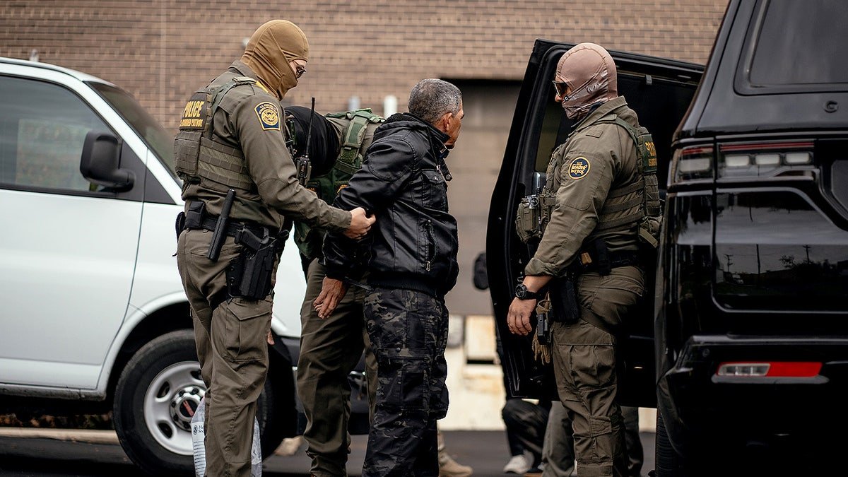 Chief Patrol Agent Gregory Bovino and federal officers detaining people in a parking lot in Chicago