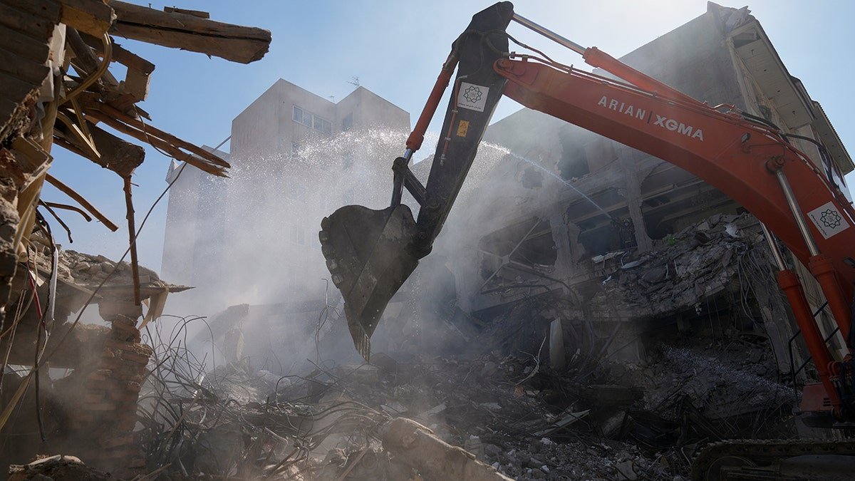 An excavator removing rubble at the Khorasaniha Synagogue site in Tehran