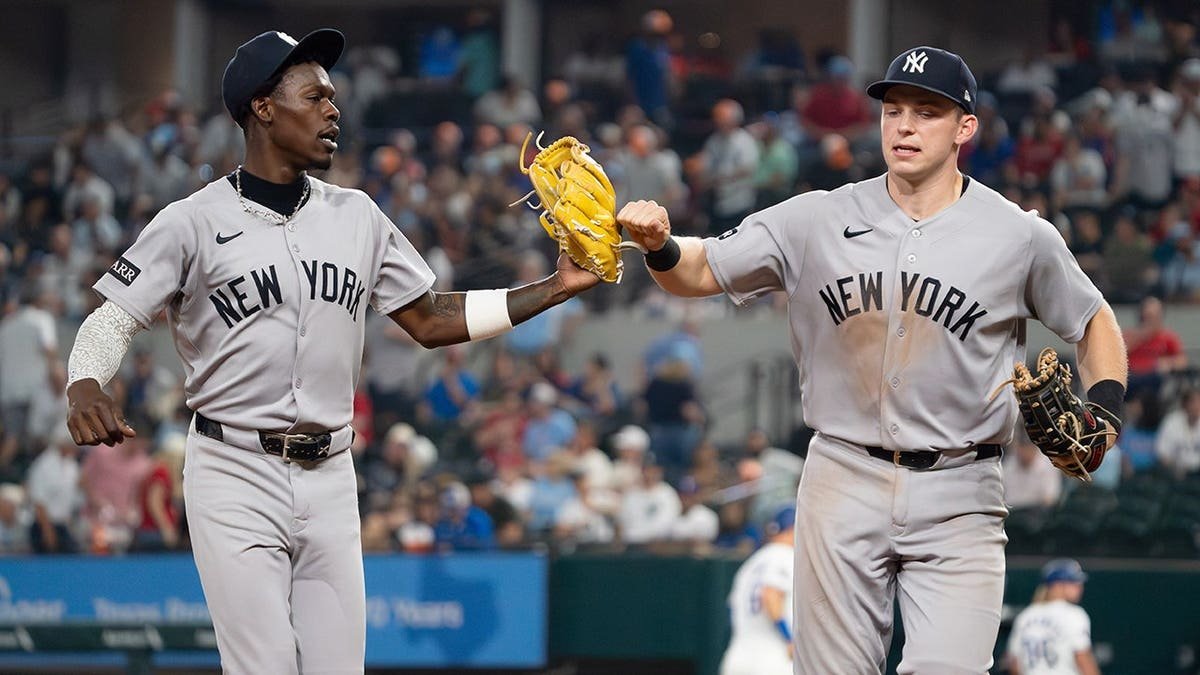 New York Yankees Jazz Chisholm Jr. and Ben Rice fist bump running off field