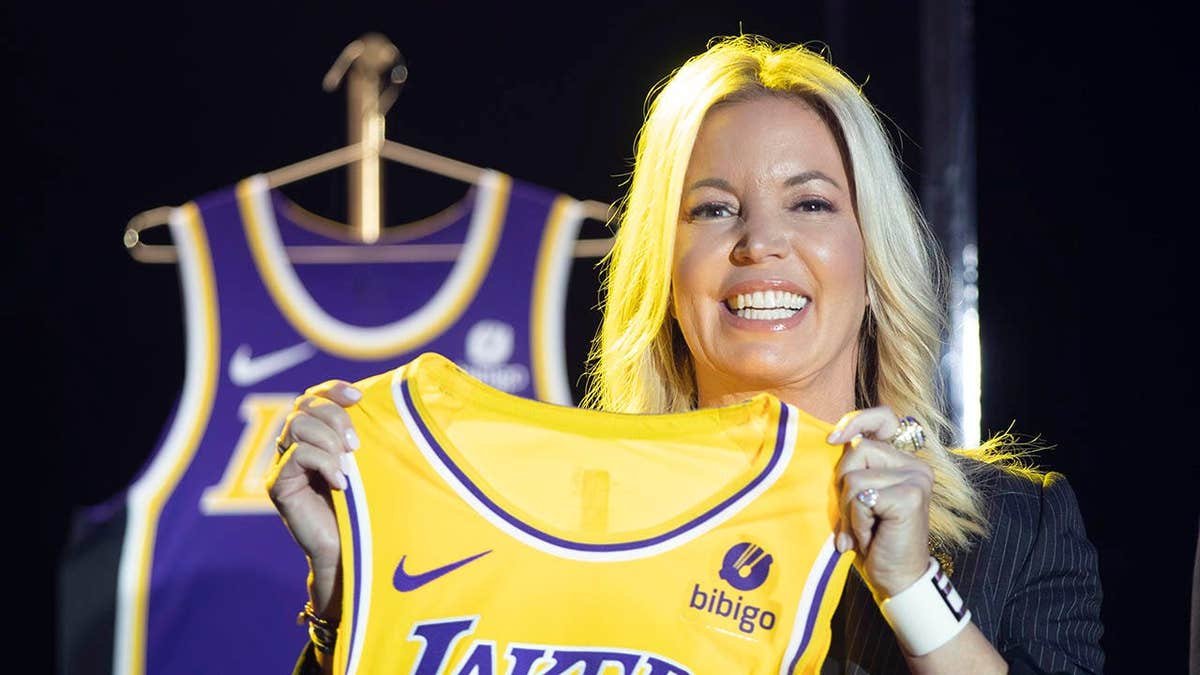 Jeanie Buss holding a new Los Angeles Lakers jersey at an event