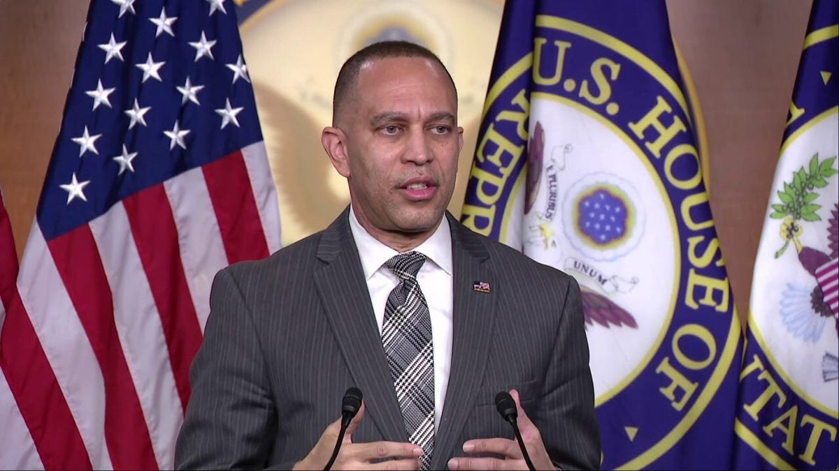 House Minority Leader Hakeem Jeffries speaking at a podium