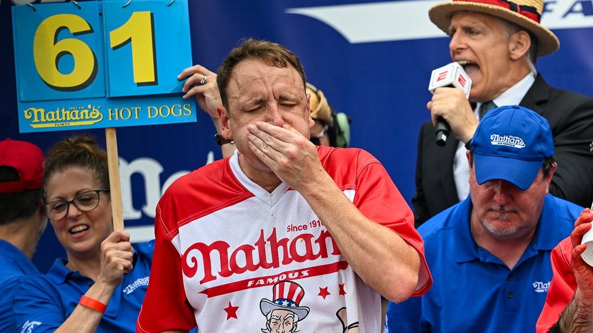 Joey Chestnut eating hot dogs during a contest at Coney Island