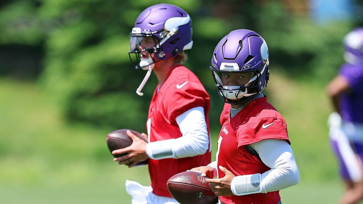 Kyler Murray wearing number 1 jersey participating in a drill at a football practice.