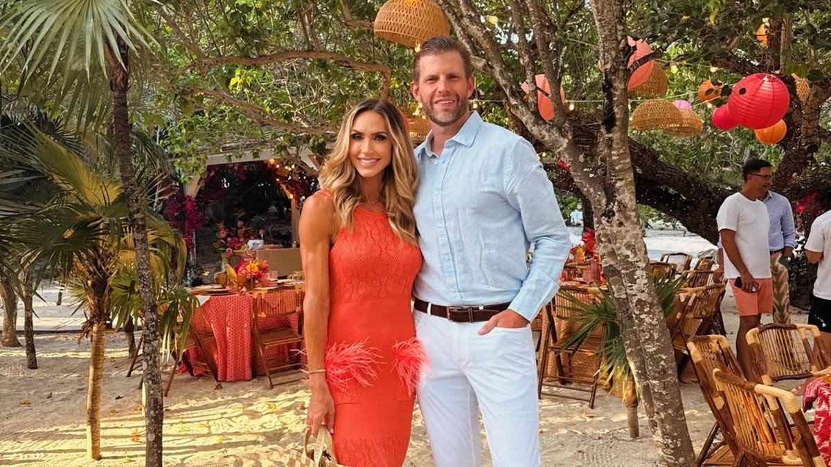 Lara Trump and Eric Trump posing together outdoors in the Bahamas