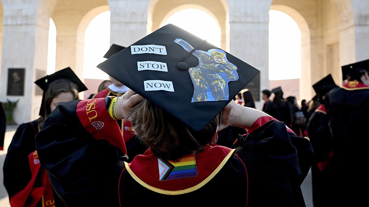 College graduate with LGBT ensignia