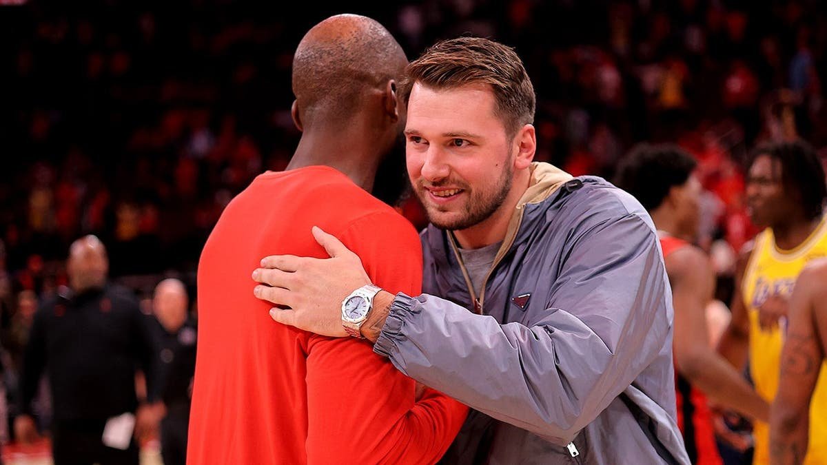 Luka Doncic greeting Jeff Green on basketball court at Toyota Center