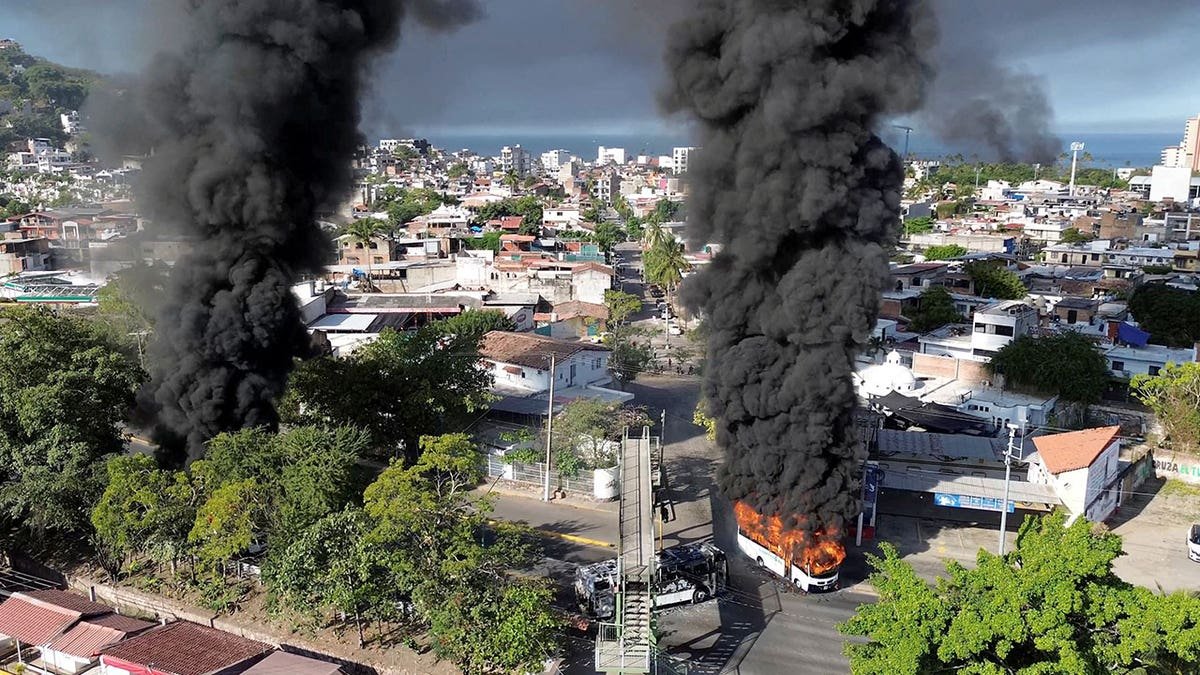 Smoke billows from burning vehicles on a highway in Puerto Vallarta, Jalisco, Mexico