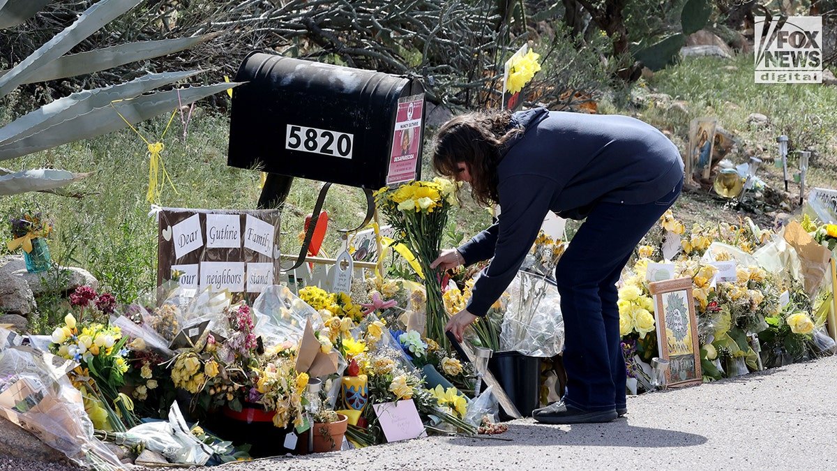 People placing flowers outside Nancy Guthrie's home in Tucson, Arizona