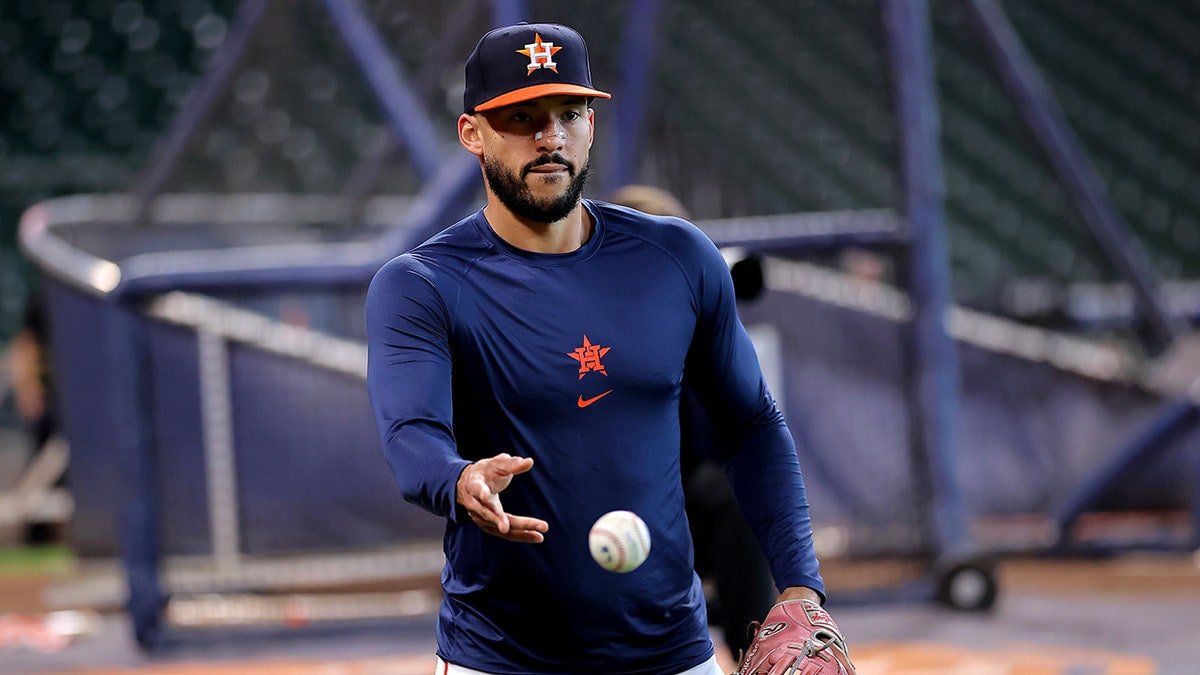 Houston Astros third baseman Carlos Correa warming up on the field at Daikin Park