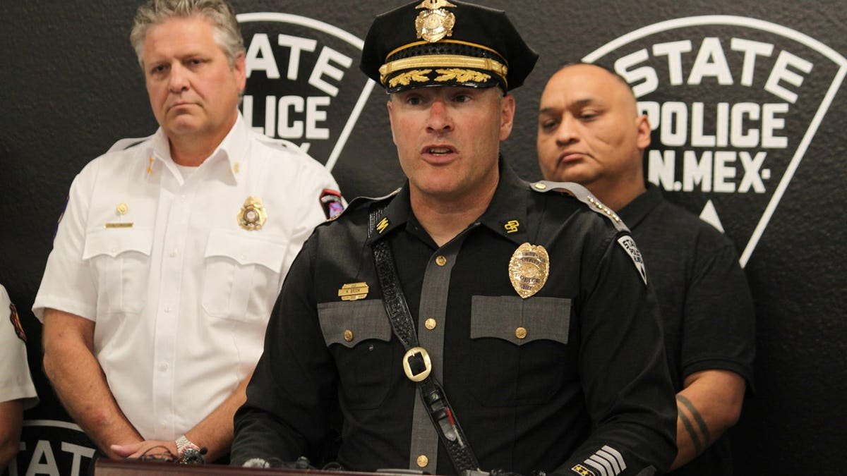 New Mexico State Police Chief Matt Broom, center, provides updates during a news conference