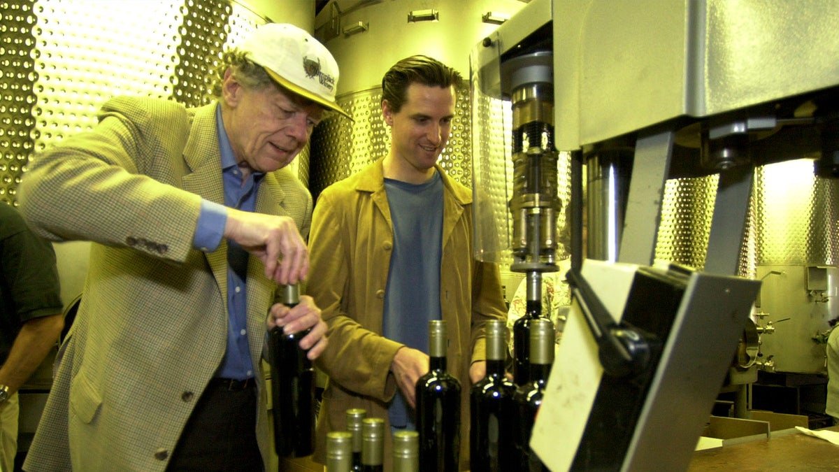 Gordon Getty and Gavin Newsom sealing wine bottles with screwcaps at Plumpjack winery.