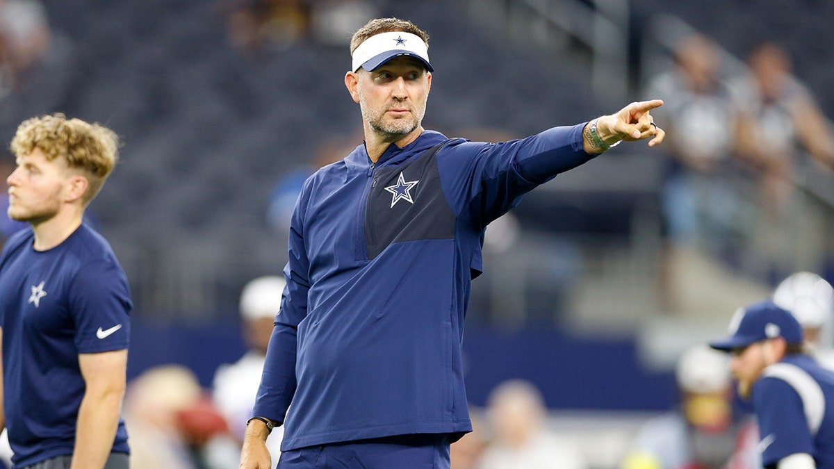 Dallas Cowboys head coach Brian Schottenheimer giving directions on the sideline at AT&T Stadium