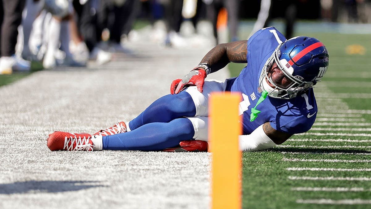 New York Giants wide receiver Malik Nabers reacting to injury on football field