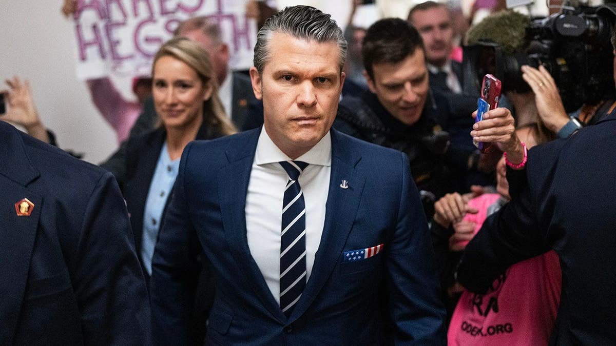 Defense Secretary Pete Hegseth and his wife Jennifer arriving at a congressional hearing