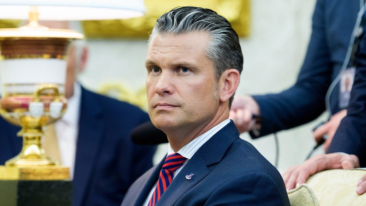 Pete Hegseth seated in the Oval Office during a meeting