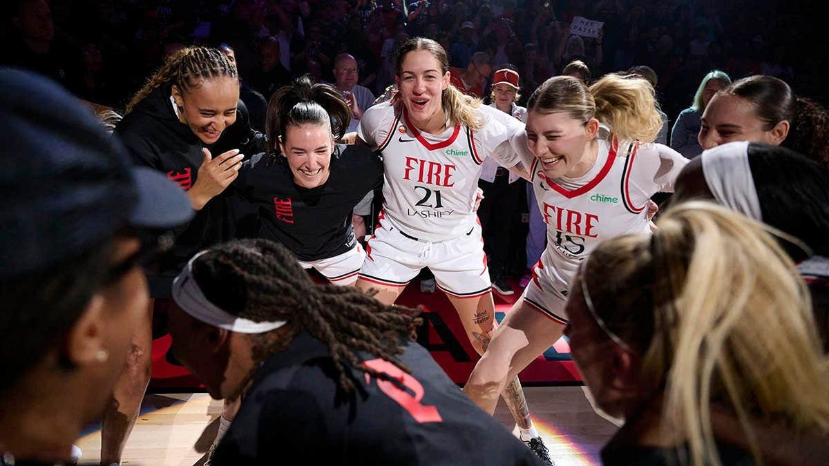 Portland Fire players Haley Jones, Bridget Carleton, Emily Engstler, and Luisa Geiselsoder huddle before a game.