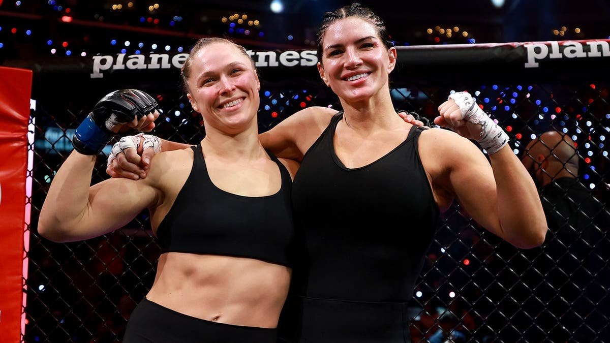 Ronda Rousey and Gina Carano posing together after featherweight bout at Intuit Dome