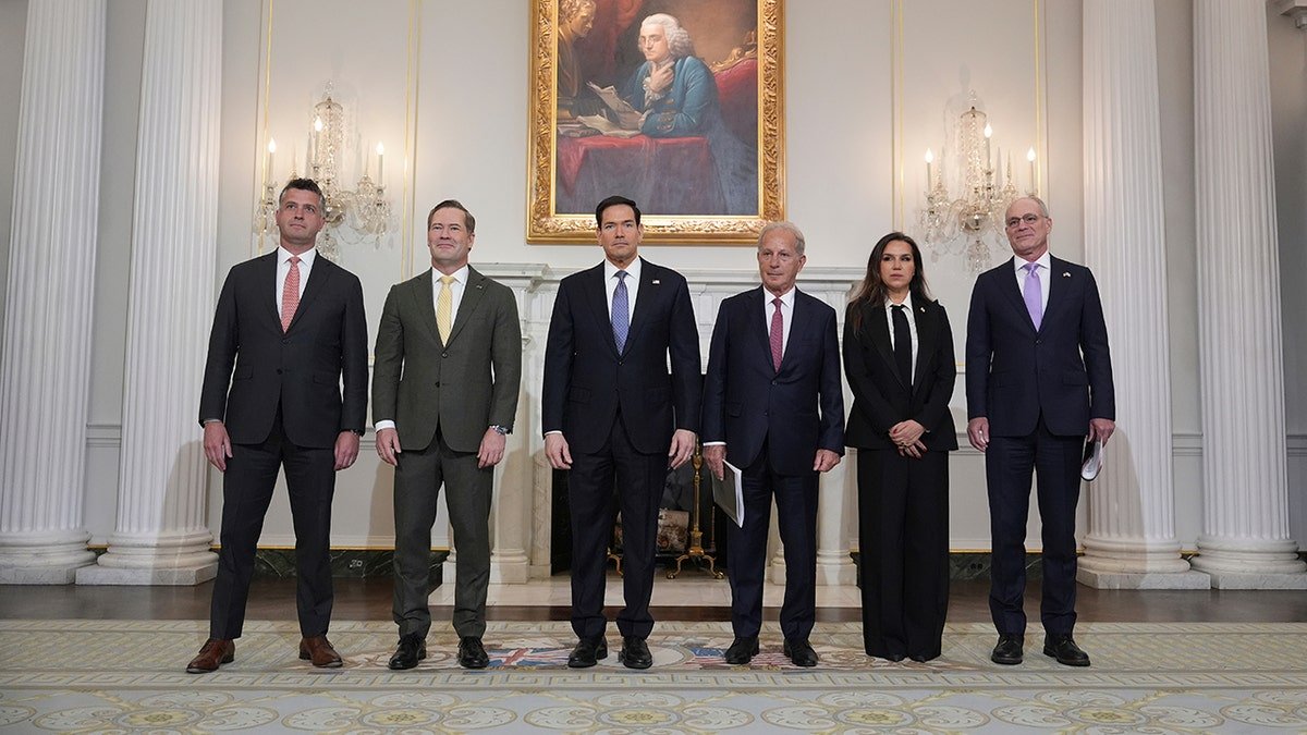 Michael Needham, Mike Waltz, Marco Rubio, Michel Issa, Nada Hamadeh Moawad, and Yechiel Leiter standing in a row inside the State Department