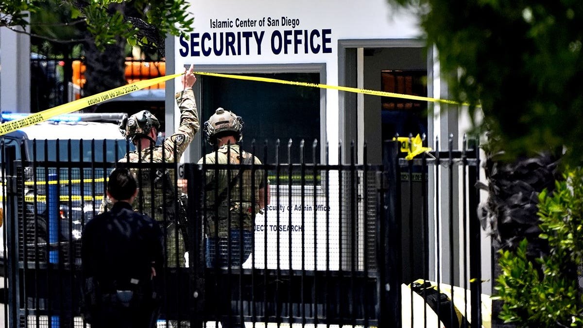 A body covered with a tarp at the scene outside the Islamic Center of San Diego