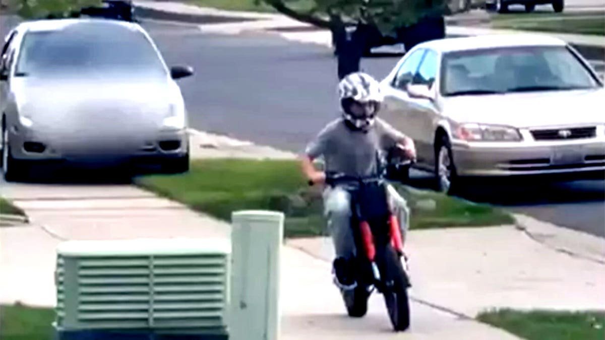 boy on dirt bike fleeing as car chases him down sidewalk