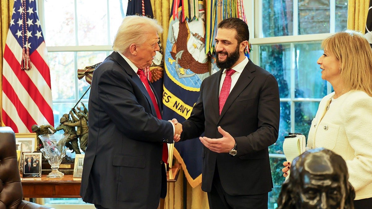 President Donald Trump shaking hands with Syrian President Ahmed al-Sharaa at the White House