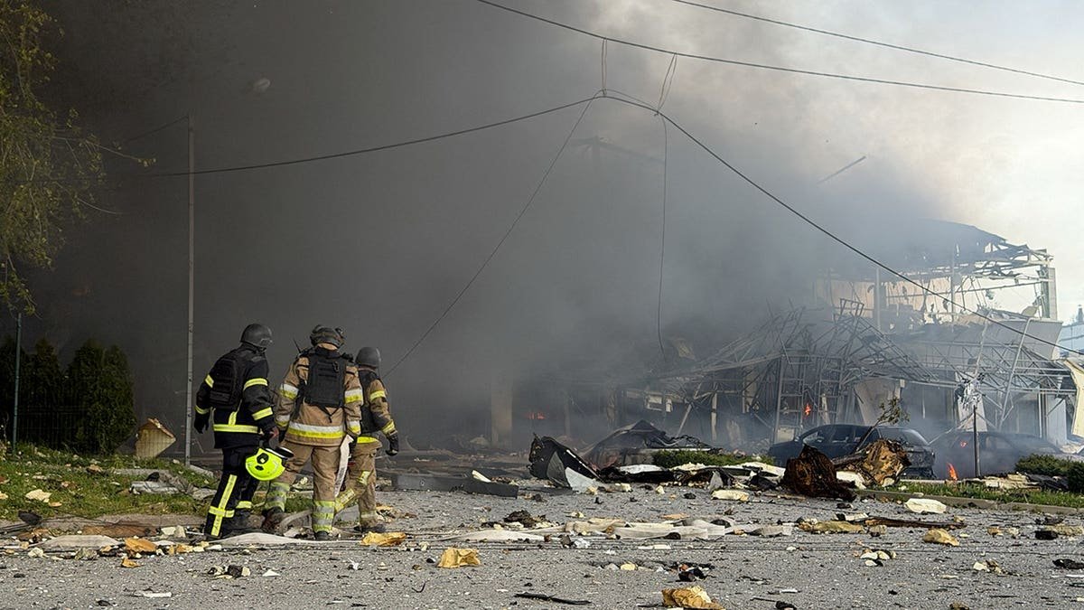 Ukrainian rescuers working at a damaged site in Zaporizhzhia