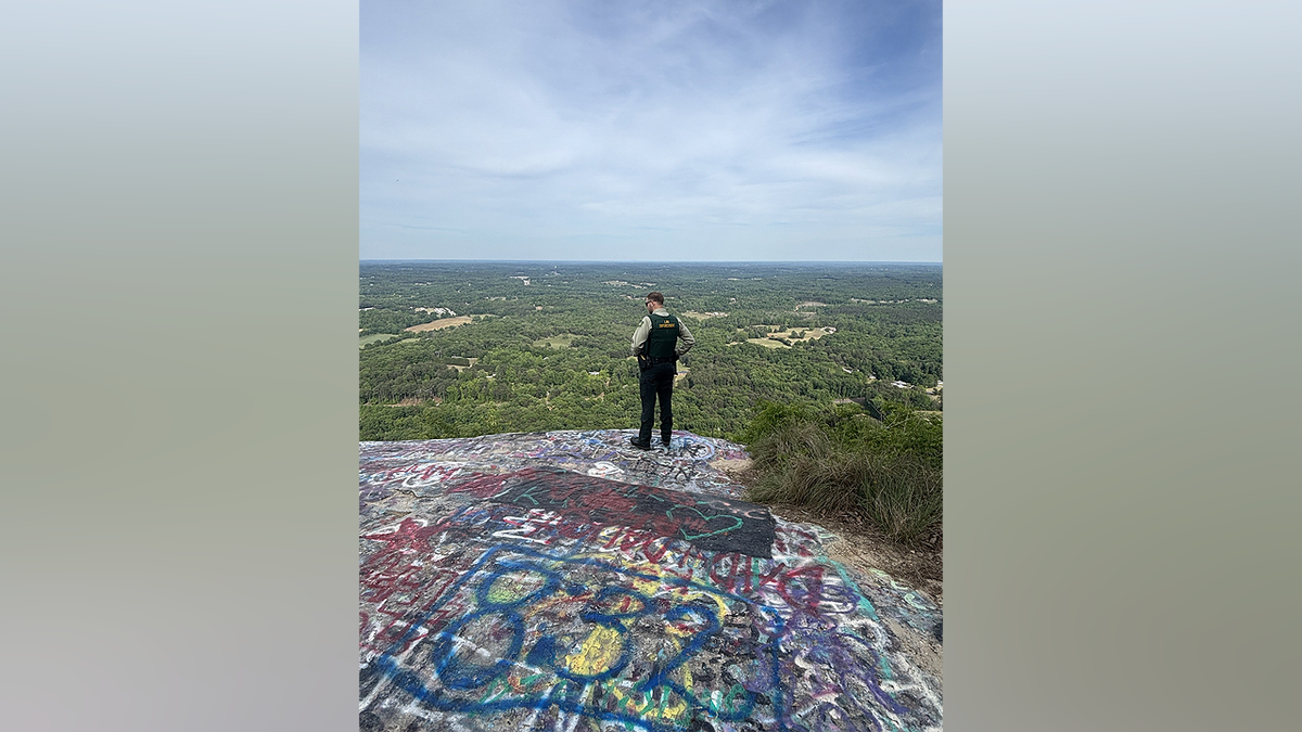 Law enforcement officers overlook forest land in Georgia during Operation Southern Forest Trident targeting illegal immigration and drug crime.