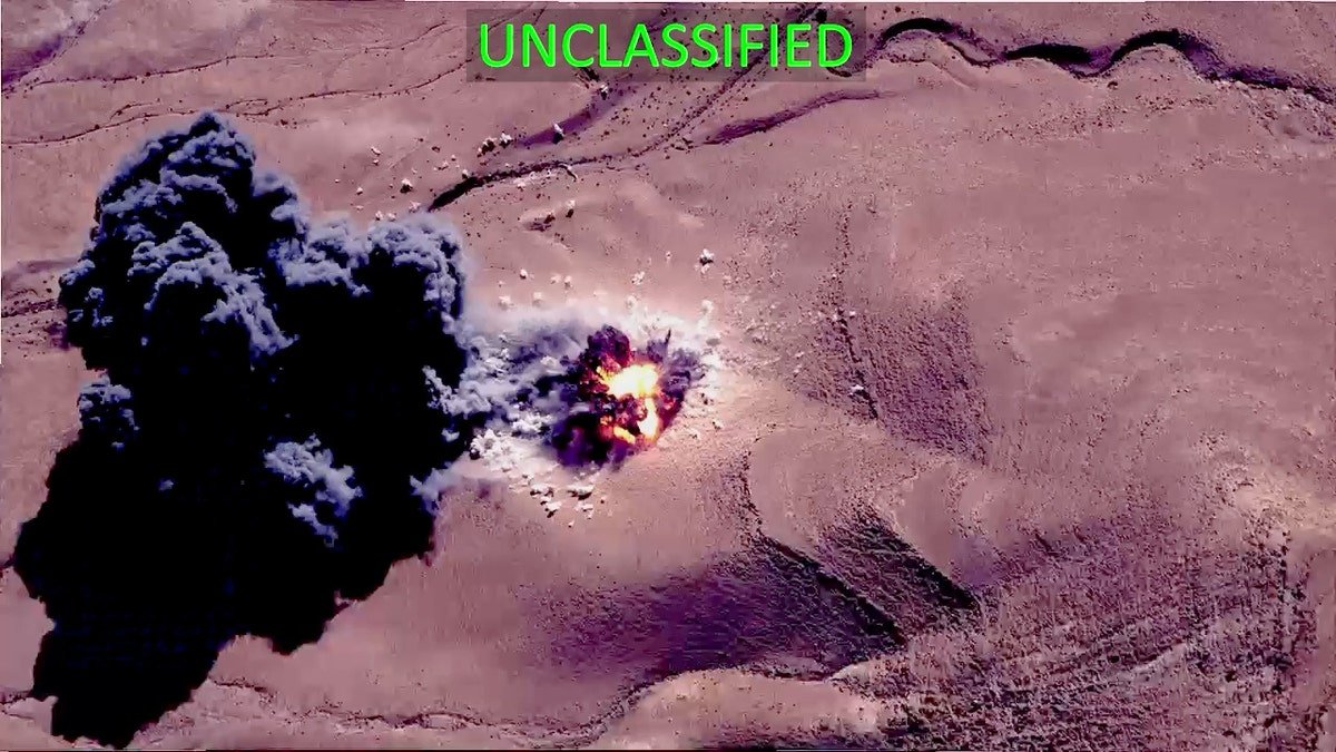 U.S. military aircraft flying over desert terrain during airstrikes in Syria