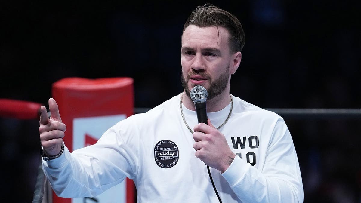 Will Ospreay speaking at a New Japan Pro-Wrestling event in Tokyo gymnasium