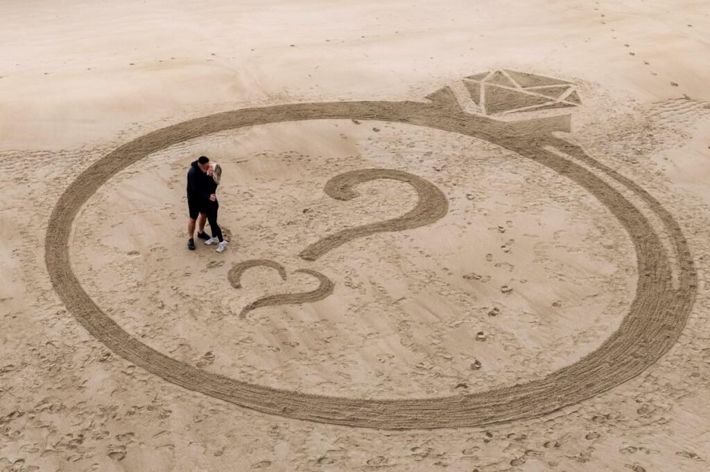 Man pops the question with massive ring carved onto beach in sand-sational proposal