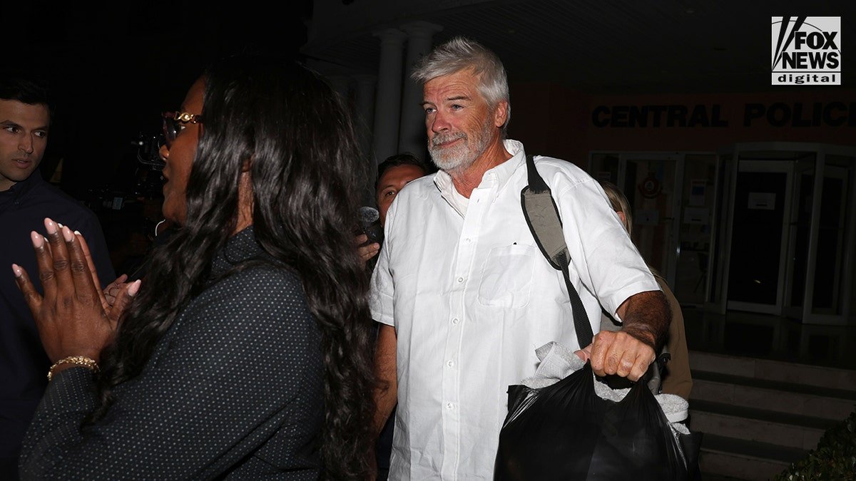 Brian Hooker leaving Central Police Station in Freeport accompanied by lawyer Terrel A. Butler
